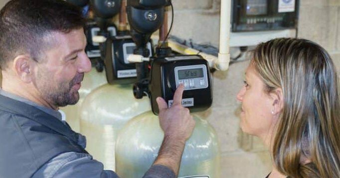 Repair Man talking to woman about water softener